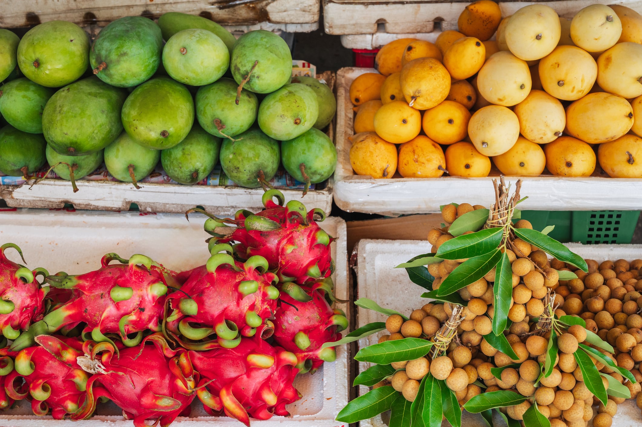 Sale of various fresh fruits at the market in Vietnam. Tropical pitaya, mangosteen, longan, mango, dragon fruit.