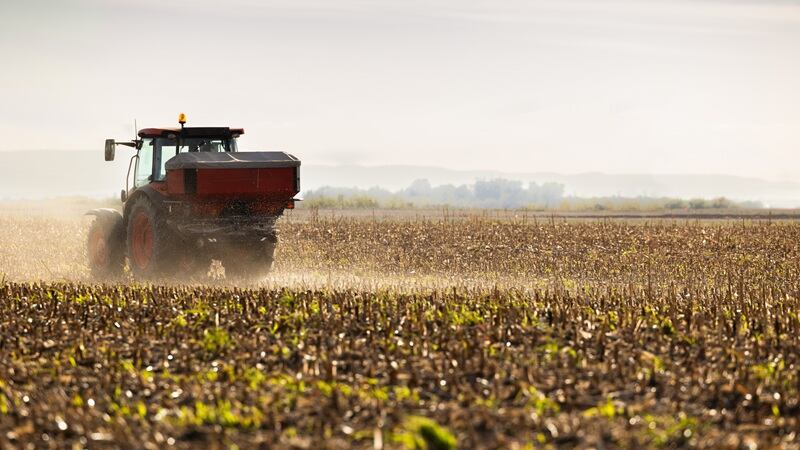 A tractor spraying fertilizer