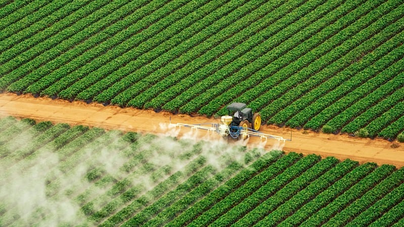 A tractor spraying fertilizers