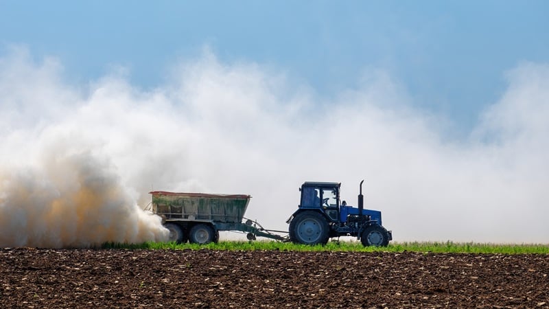 A tractor spreading potash