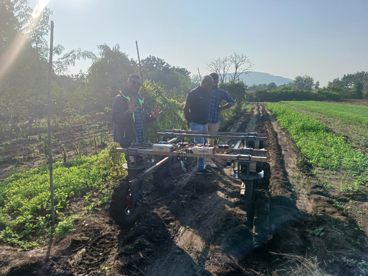 Modern Village Foundation team on field demonstrating agri rover