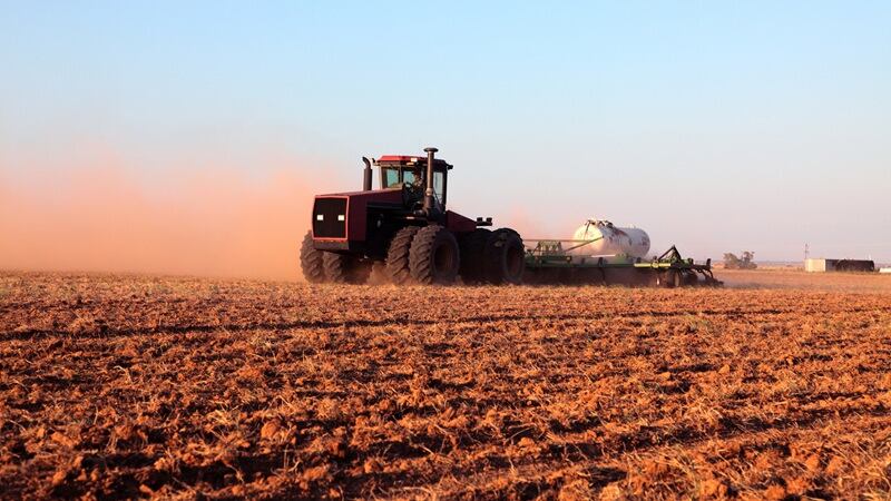 A tractor pulling an ammonia tank
